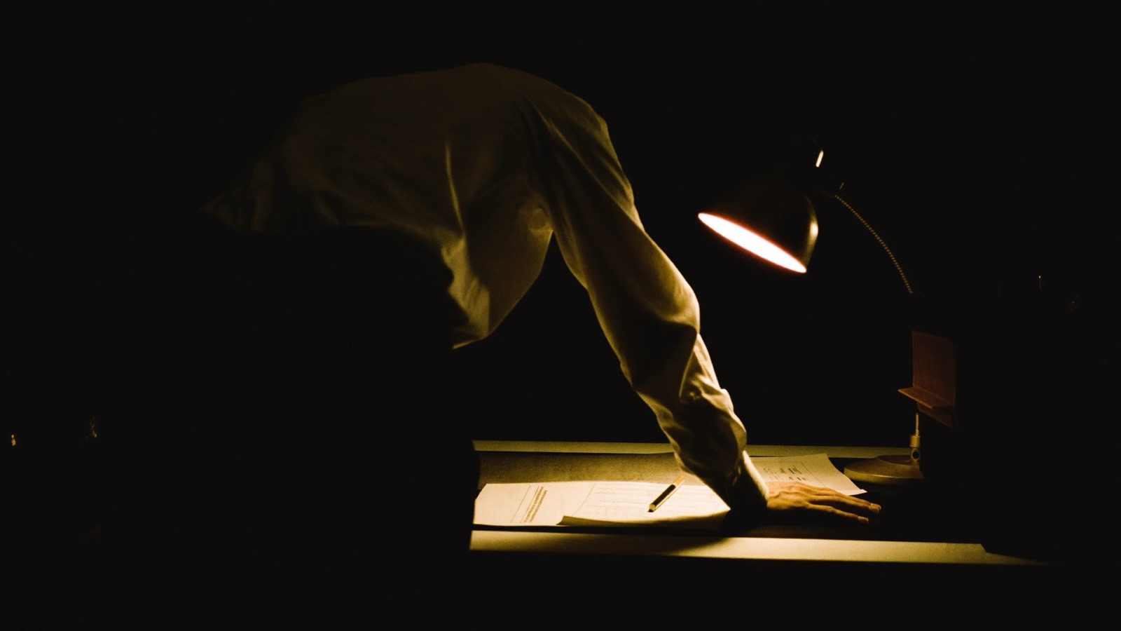 A broker working late over a client's file
